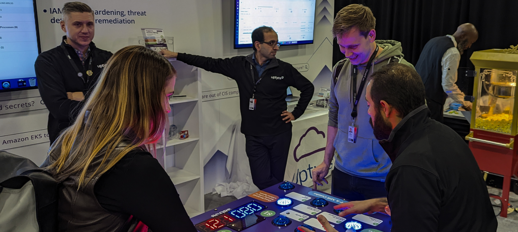 people play a game at an uptycs event
