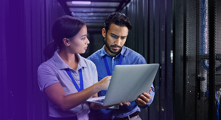 two cloud security architects looking at a laptop together