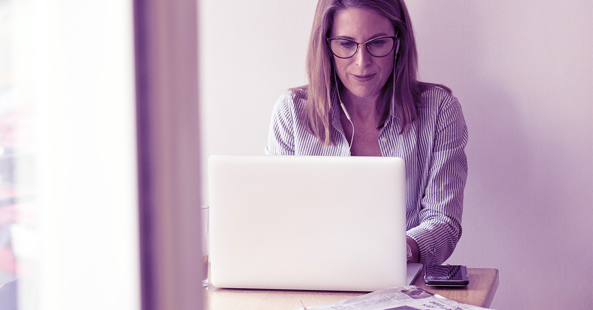 a woman with blonde hair working on a laptop